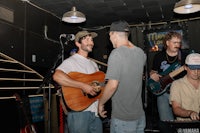 a group of people playing music in a bar