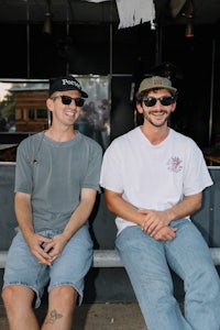 two men sitting on a bench