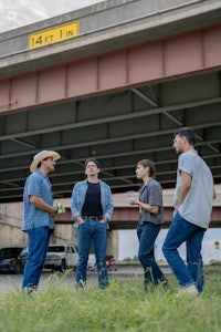 a group of people standing under a bridge