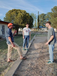 a group of men standing on a sidewalk