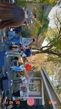 a group of people on a stage in front of a house