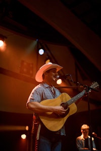 a man playing an acoustic guitar