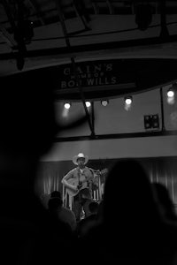 a man in a cowboy hat performs at a concert