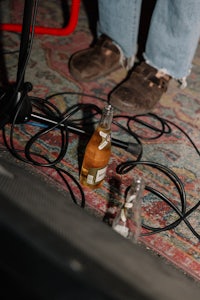 a bottle of beer on a rug