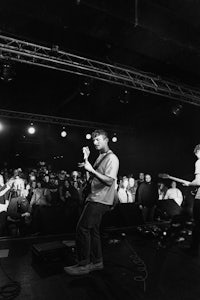 a black and white photo of a group of people on stage